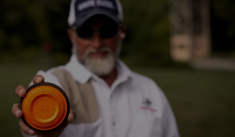 Man out-of-focus holding a White Flyer AA Eco Flyer target