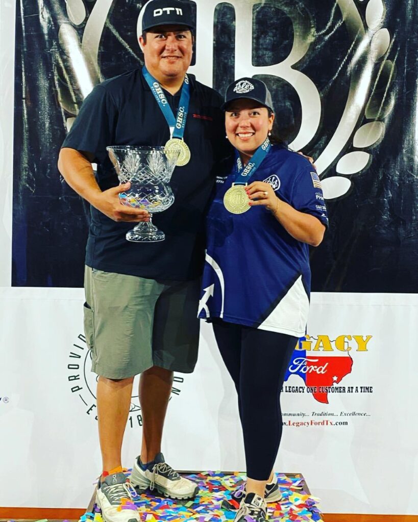 Zach Kienbaum and Meagan Herrington pose with trophies on the winner's stand