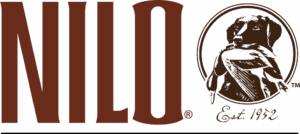 NILO Farms logo featuring Est. 1952 notation and illustration of the legendary dog, King Buck, carrying a duck in his mouth