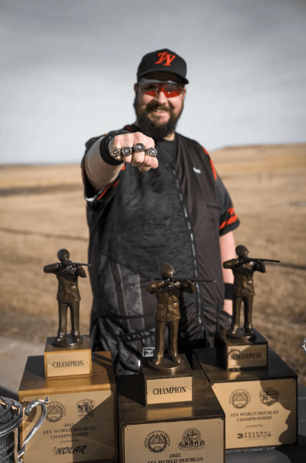 Matt Bartholow showing his award rings and trophies